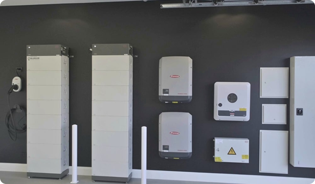 Commercial battery cabinets and inverters mounted on a wall