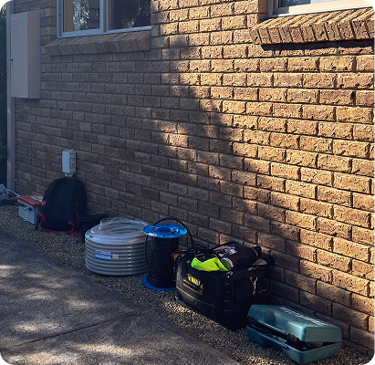 Cable reels and tool bags against the brick wall