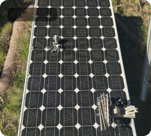 Solar panels laid out beside mounting rails