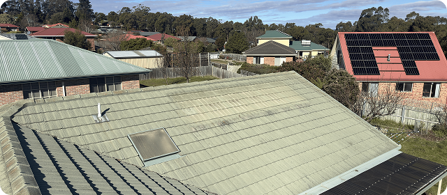 Neighbouring roofs, with solar panels on a red roof